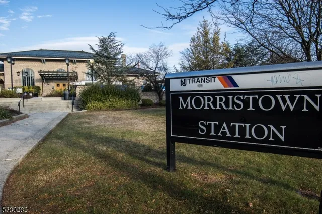 a sign broad in front of the red brick house