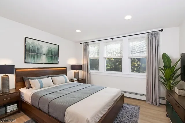 a bedroom with a large bed and a large window