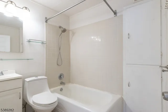 a white toilet sitting next to a bath tub