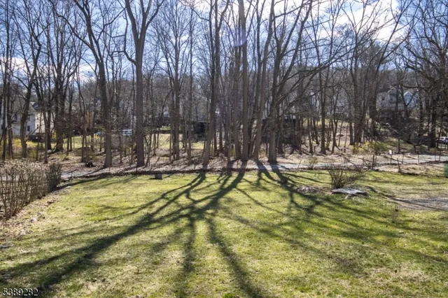 a view of swimming pool with a bench and trees
