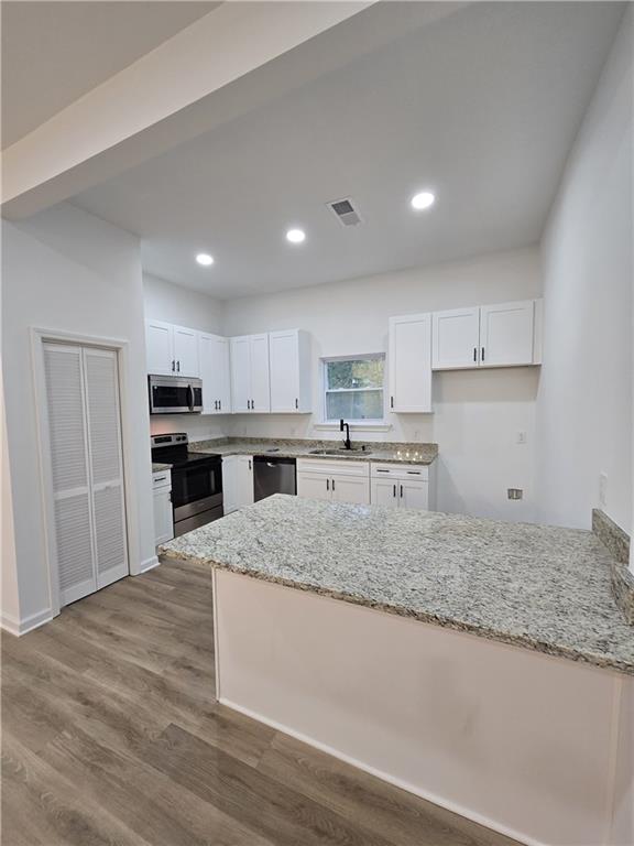 4645 Gordon Street Fairburn, GA 30213 - Photo 11 of 17 a kitchen with stainless steel appliances granite countertop a sink stove and refrigerator