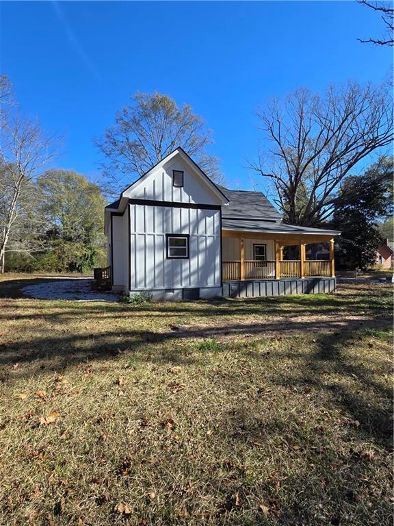 4645 Gordon Street Fairburn, GA 30213 - Photo 2 of 17 a front view of a house with a wooden deck