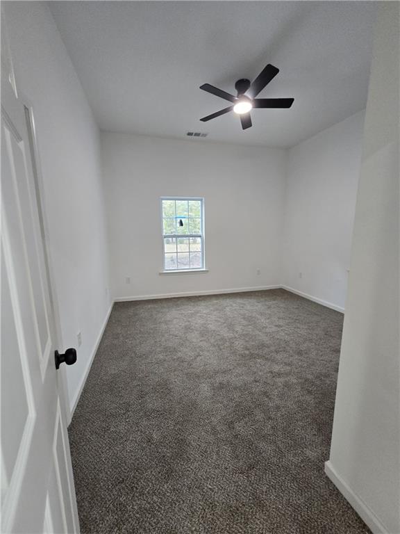 4645 Gordon Street Fairburn, GA 30213 - Photo 8 of 17 a view of a livingroom with a ceiling fan and window