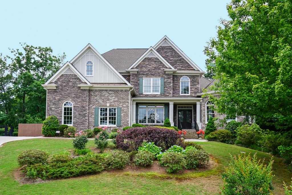 This luxurious, yet comfortable hilltop haven of 4-sides brick and stone has a nice front porch and impressive wrought iron-decorated double-door entry.