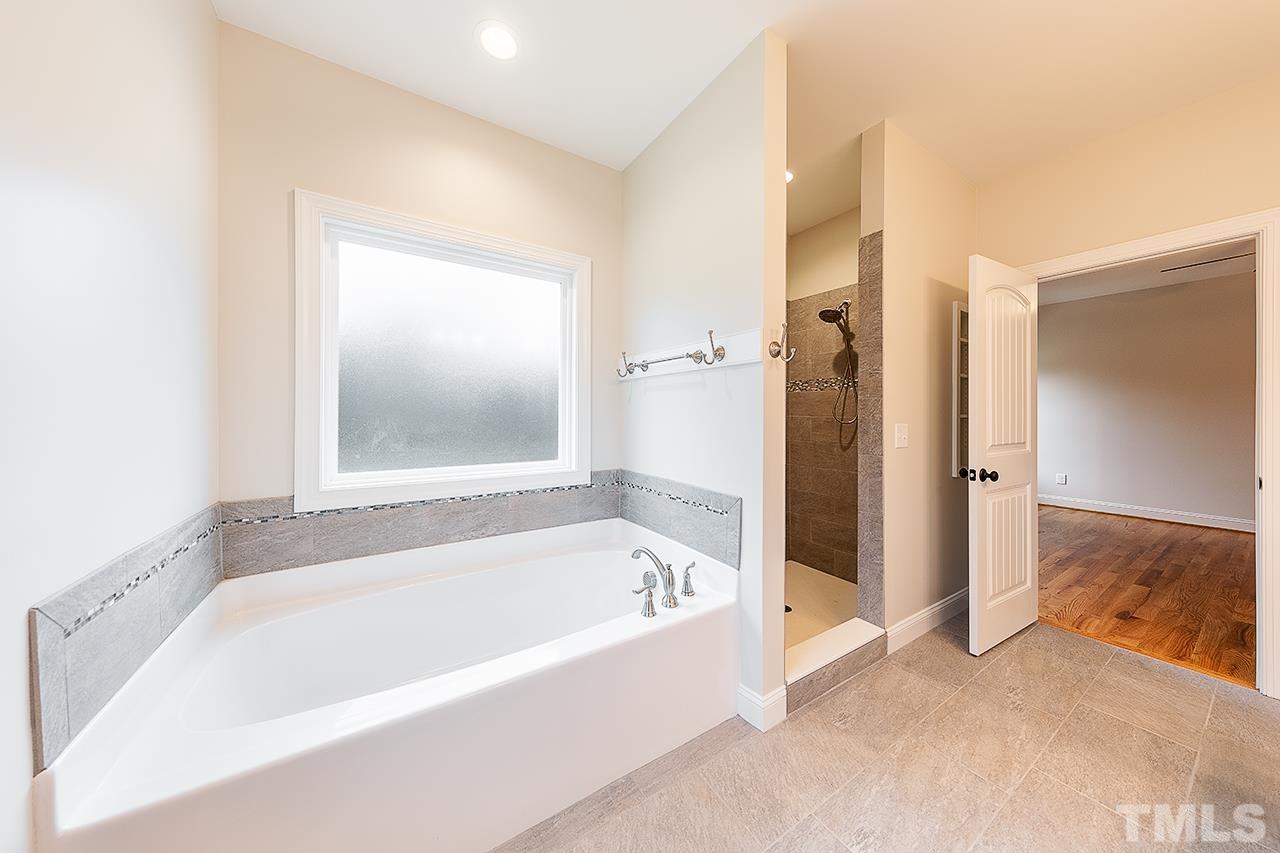 L9 Harvest Rdg Road Battleboro, NC 27809 - Photo 3 of 18 a spacious bathroom with a bathtub and a shower