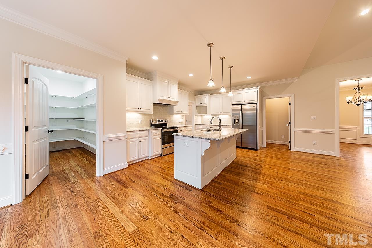 L9 Harvest Rdg Road Battleboro, NC 27809 - Photo 5 of 18 a large kitchen with stainless steel appliances kitchen island a large counter top and a wooden floors