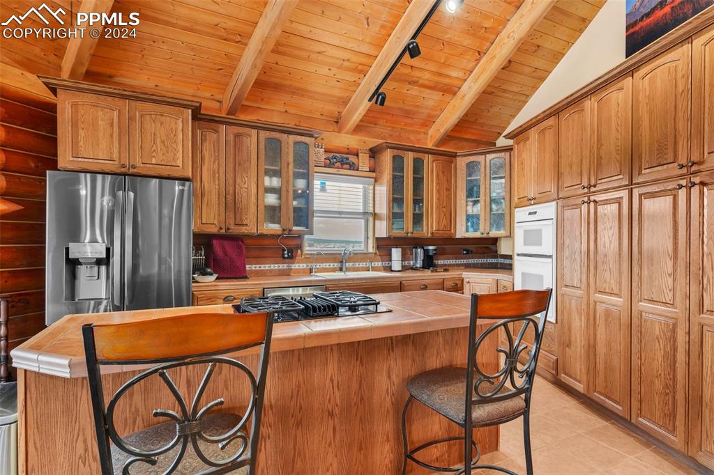 1747 Newton Road Pueblo, CO 81005 - Photo 15 of 50 a kitchen with stainless steel appliances granite countertop a stove a sink dishwasher and cabinets with wooden floor