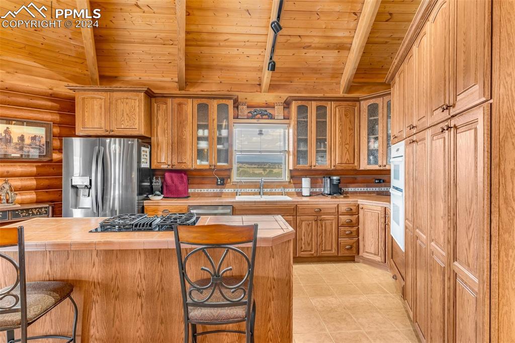 1747 Newton Road Pueblo, CO 81005 - Photo 16 of 50 a kitchen with refrigerator and cabinets