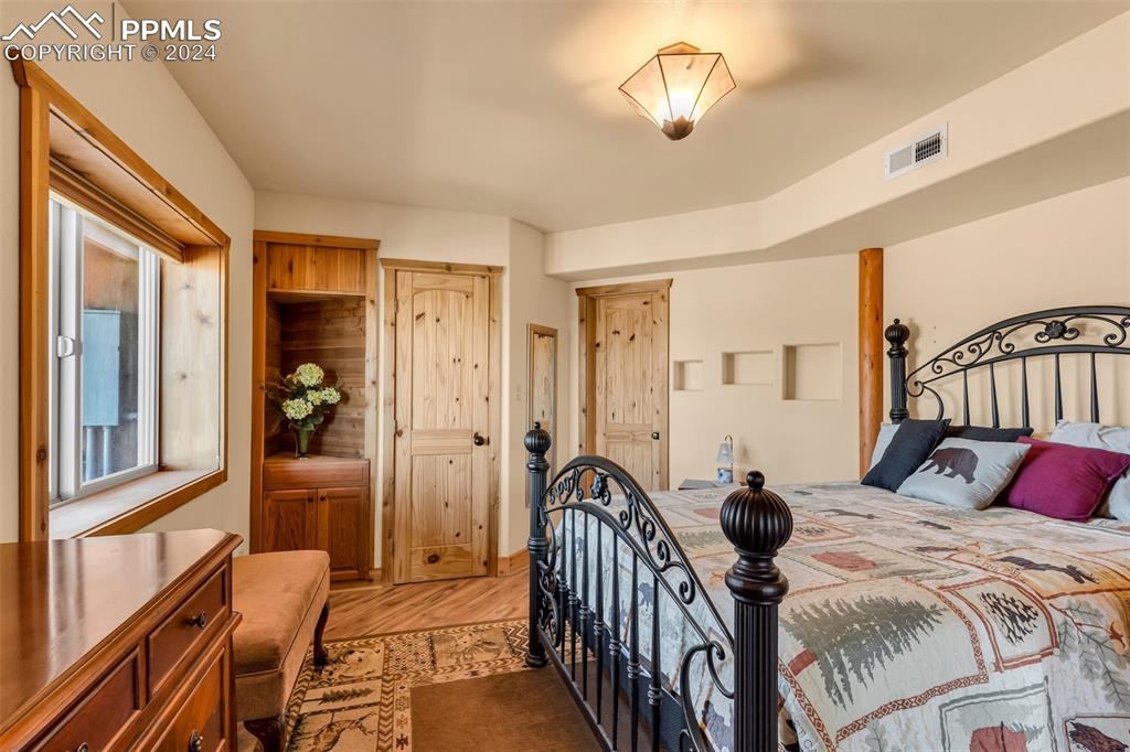 1747 Newton Road Pueblo, CO 81005 - Photo 30 of 50 a bedroom with a bed and a chandelier