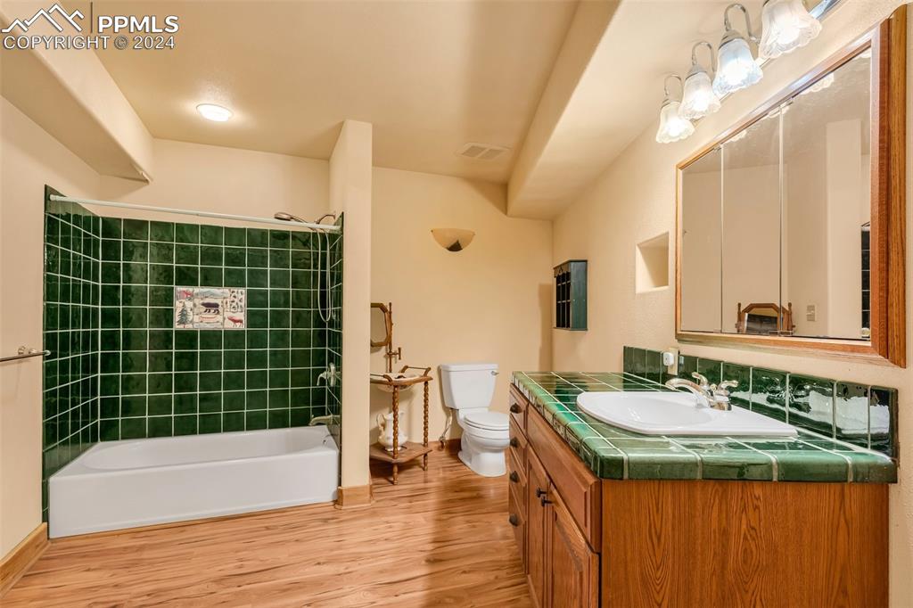 1747 Newton Road Pueblo, CO 81005 - Photo 31 of 50 a bathroom with a granite countertop sink a mirror and a bathtub