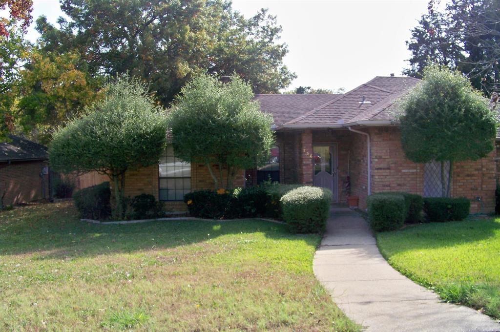 Undisclosed Address DeSoto, TX 75115 - Photo 1 of 1 a front view of a house with a garden