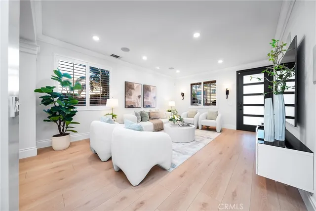 a living room with furniture potted plant and windows