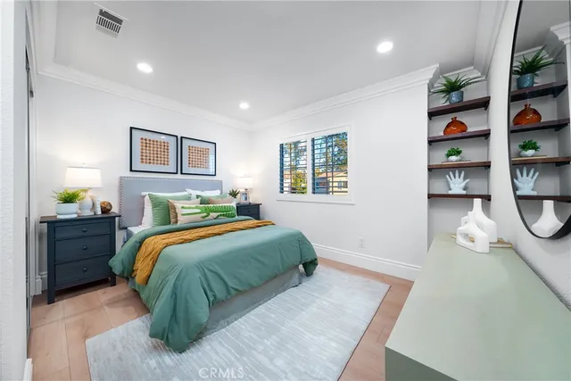 a view of a hallway to a livingroom with furniture and windows