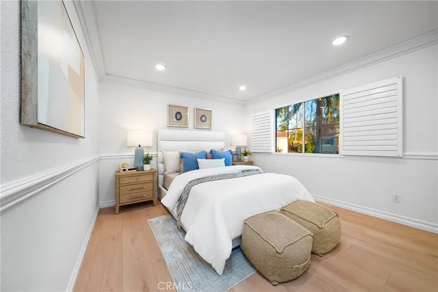 a bedroom with a bed and a potted plant