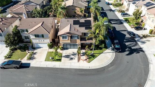 an aerial view of residential house with outdoor space and parking