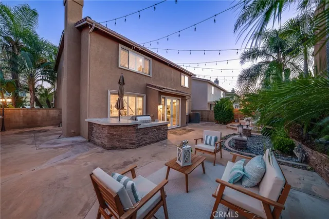 a view of a patio with table and chairs and potted plants