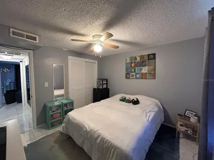 a bedroom with a bed and a chandelier