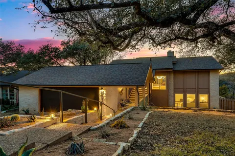 a backyard of a house with yard fire pit and outdoor seating