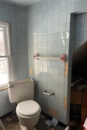 a white toilet sitting next to a bathroom sink