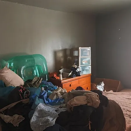 a bedroom with bed and a couch
