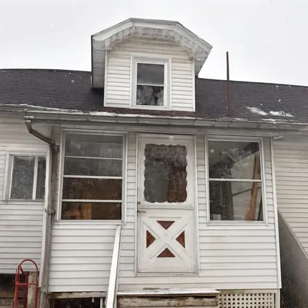 a view of a house with a door and a window