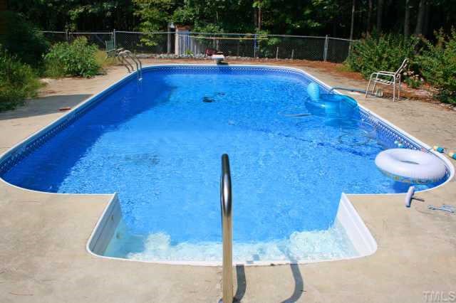 4 Orion Circle Rougemont, NC 27572 - Photo 6 of 8 a view of a swimming pool with a lounge chair