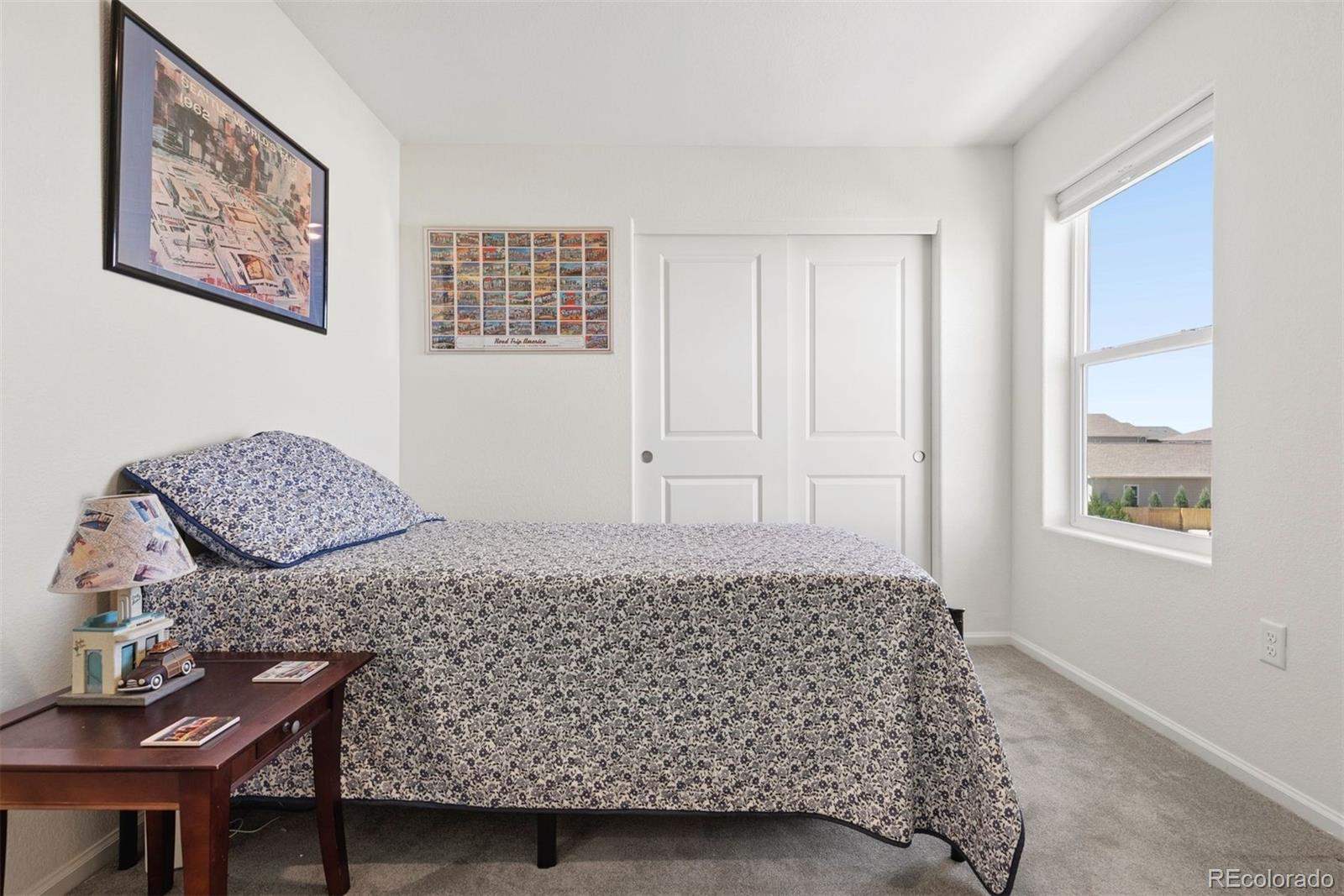7307 Animas Avenue Frederick, CO 80530 - Photo 32 of 49 a bedroom with a bed and furniture