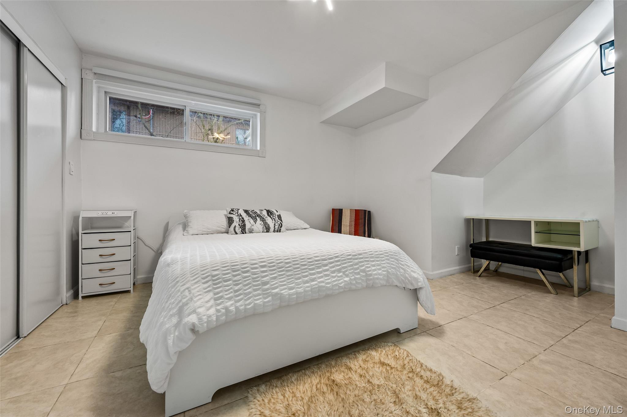 1016 Westwood Road Woodmere, NY 11598 - Photo 16 of 23 a bedroom with a bed and a table