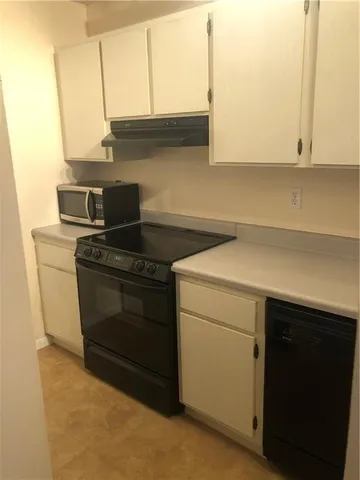 a kitchen with a sink and a stove