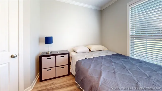 a bedroom with a bed and a night stand