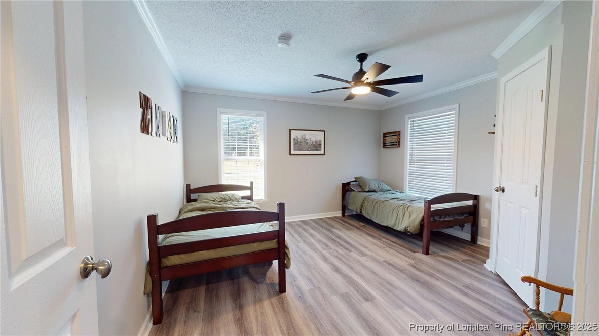 120 Mockingbird Lane Spring Lake, NC 28390 - Photo 14 of 23 a bedroom with a bed and a chandelier