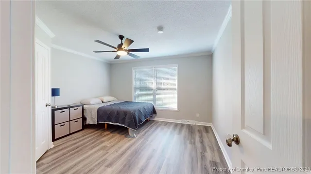 a very nice looking room with a window and a ceiling fan