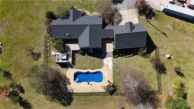 an aerial view of house with yard swimming pool and outdoor seating