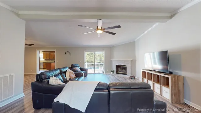 a living room with furniture a fireplace and a flat screen tv