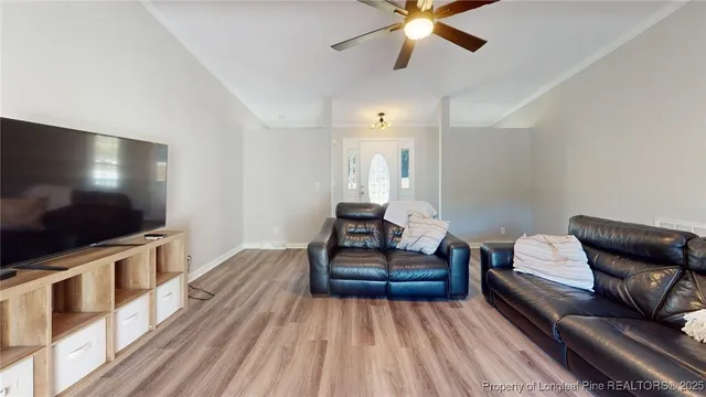 a living room with furniture and a flat screen tv