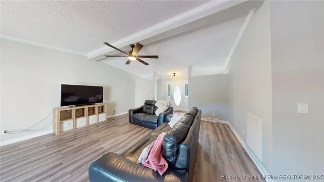 a living room with furniture and a flat screen tv