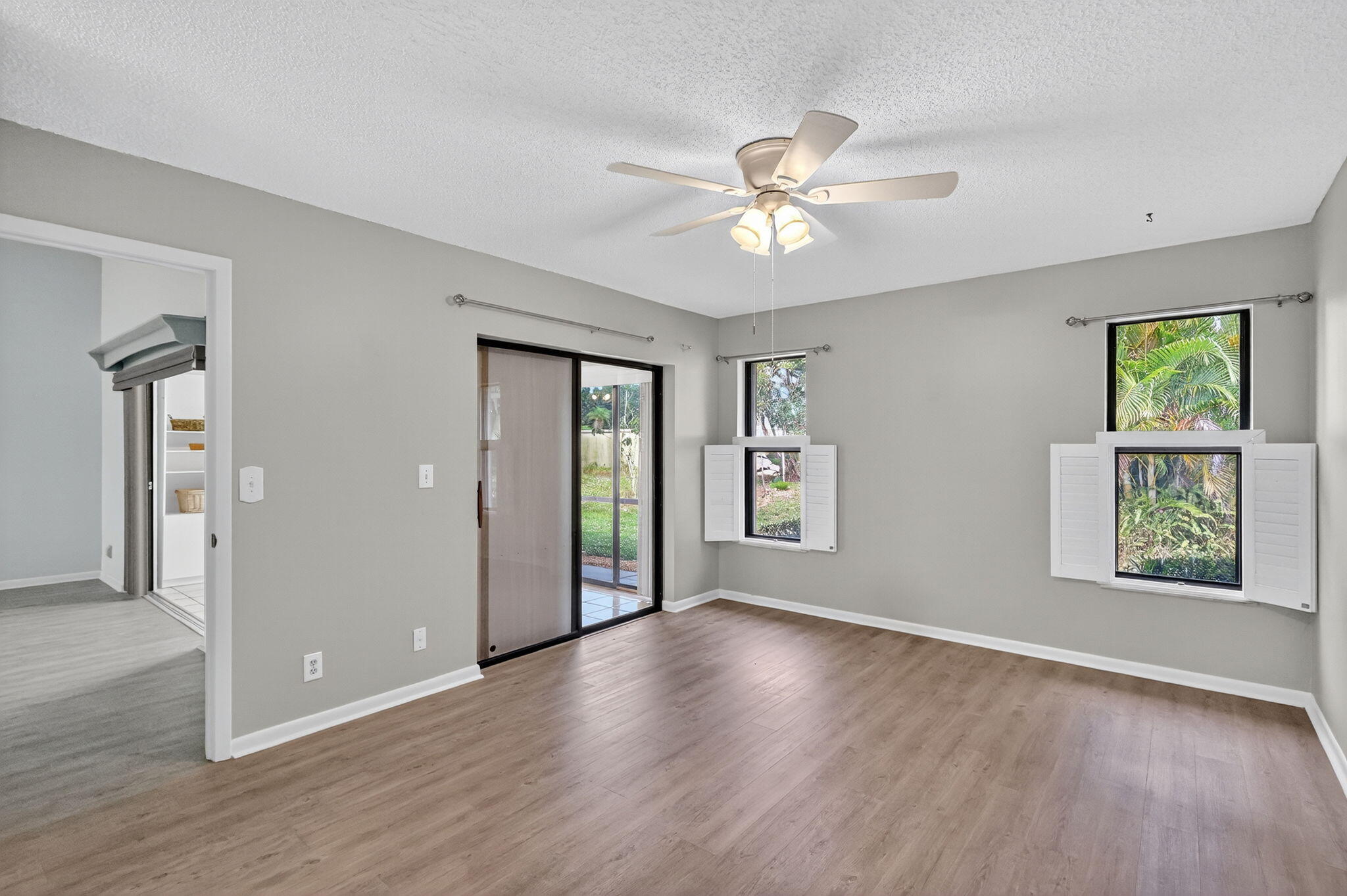 7643 Southeast Sugar Sand Circle Hobe Sound, FL 33455 - Photo 12 of 44 a view of an empty room with window and wooden floor