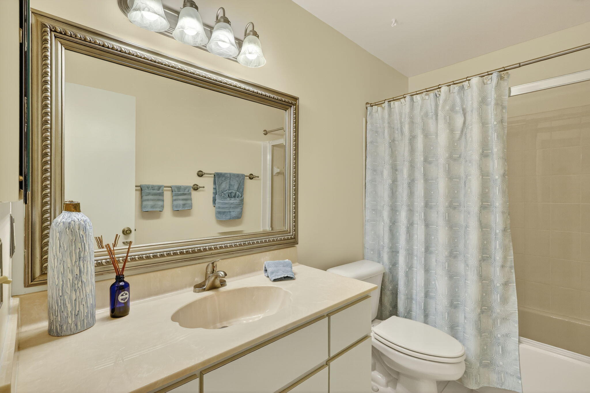 7643 Southeast Sugar Sand Circle Hobe Sound, FL 33455 - Photo 18 of 44 a bathroom with a sink vanity mirror and toilet