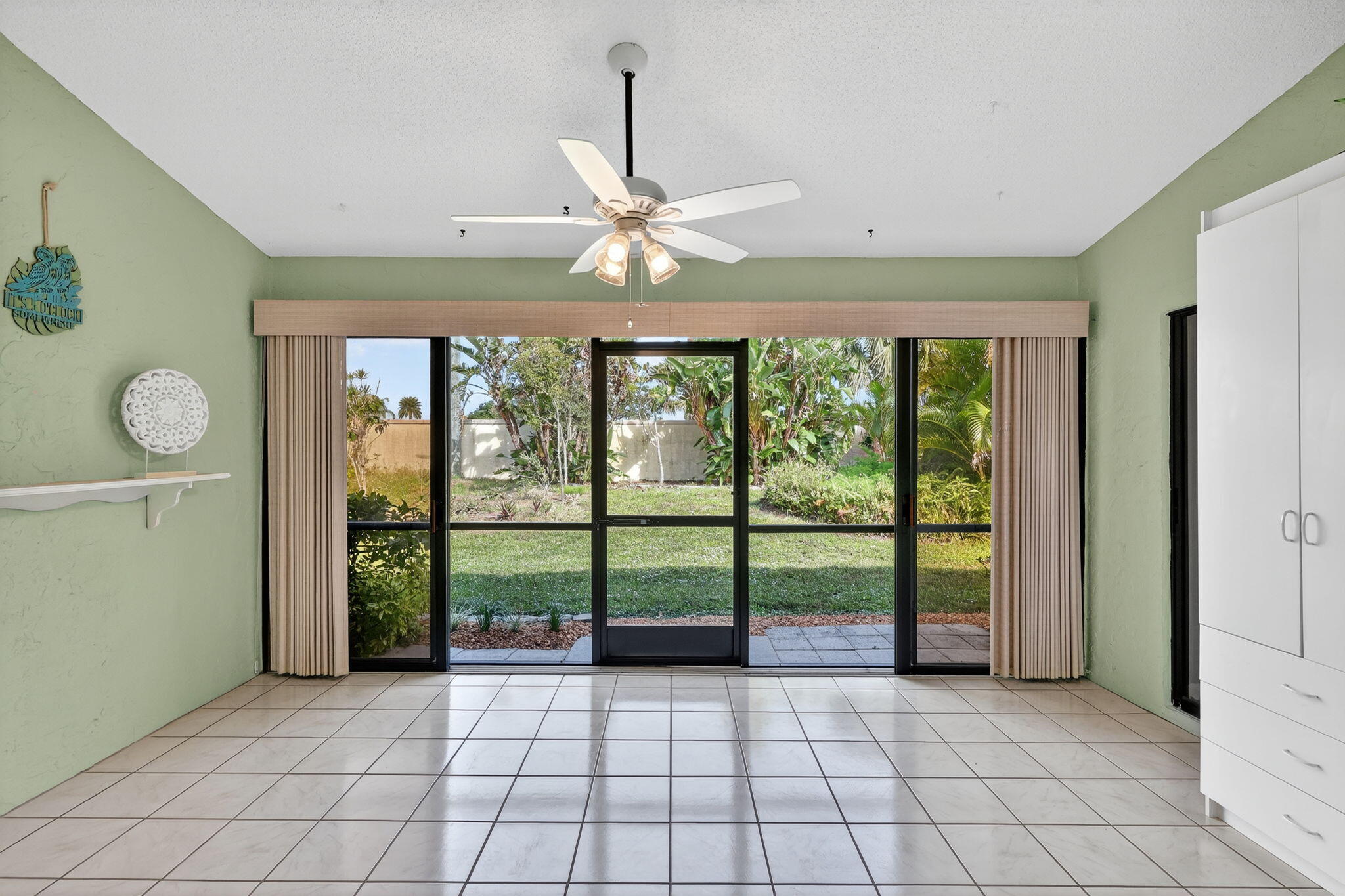 7643 Southeast Sugar Sand Circle Hobe Sound, FL 33455 - Photo 20 of 44 a view of room with window and ceiling fan