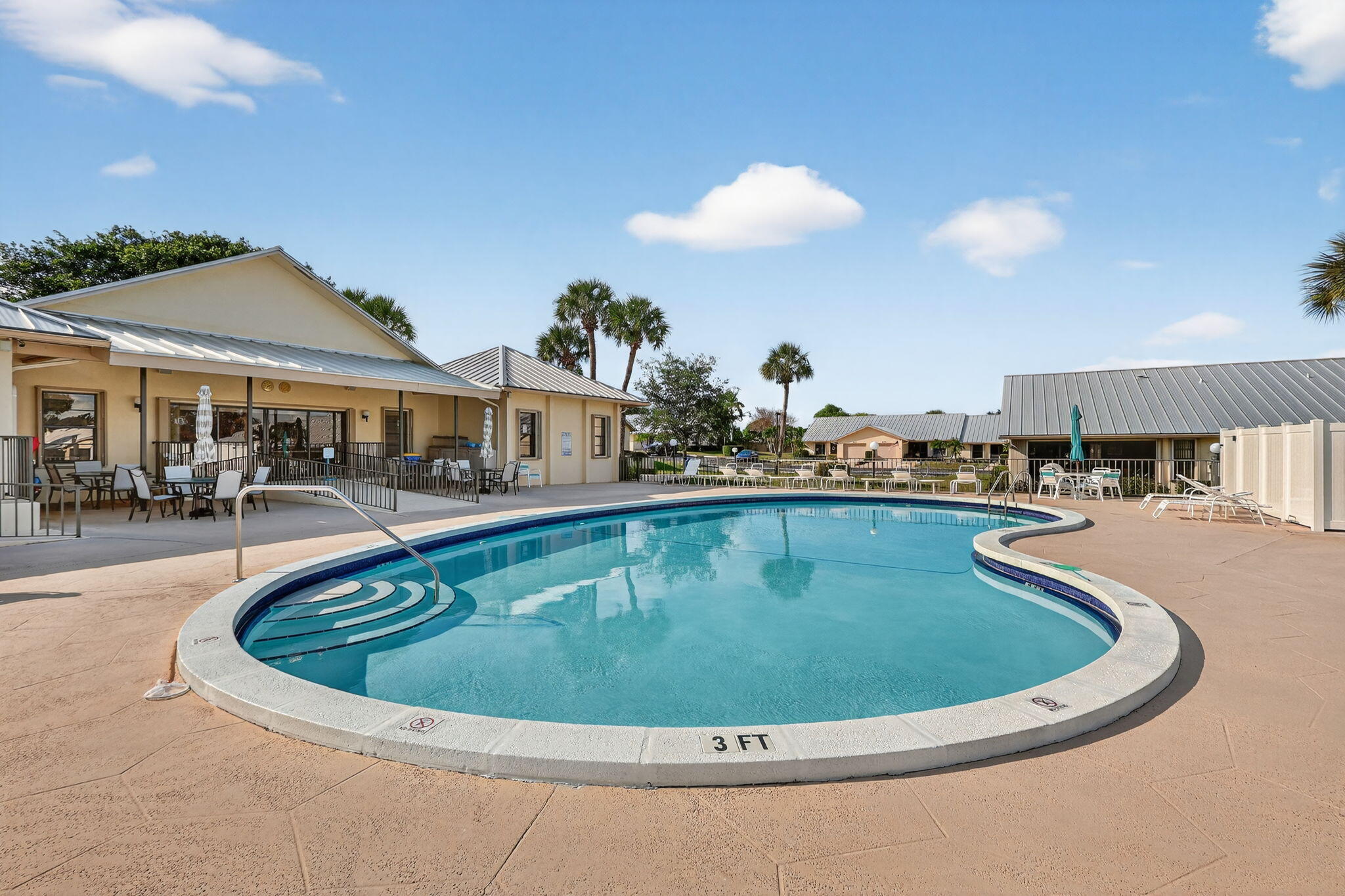 7643 Southeast Sugar Sand Circle Hobe Sound, FL 33455 - Photo 27 of 44 a view of a swimming pool with outdoor seating