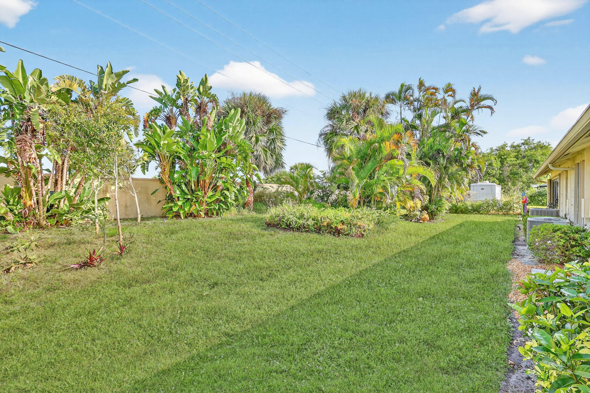 7643 Southeast Sugar Sand Circle Hobe Sound, FL 33455 - Photo 36 of 44 a view of a garden with plants