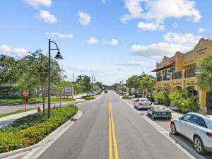 7643 Southeast Sugar Sand Circle Hobe Sound, FL 33455 - Photo 40 of 44 a view of a city street with a car parked on the road