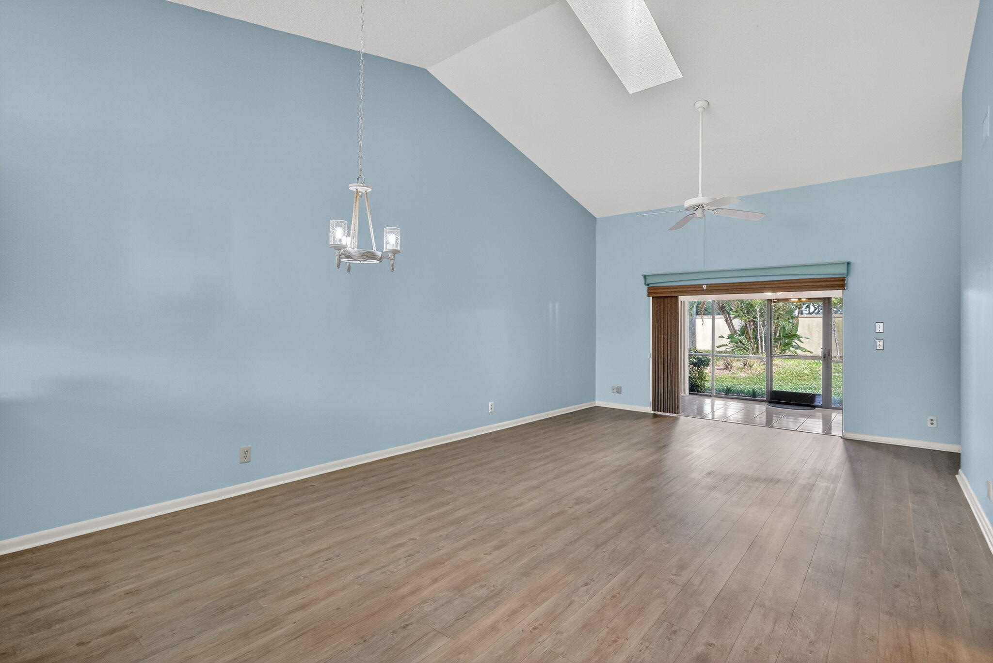 7643 Southeast Sugar Sand Circle Hobe Sound, FL 33455 - Photo 5 of 44 a view of an empty room with wooden floor and a window