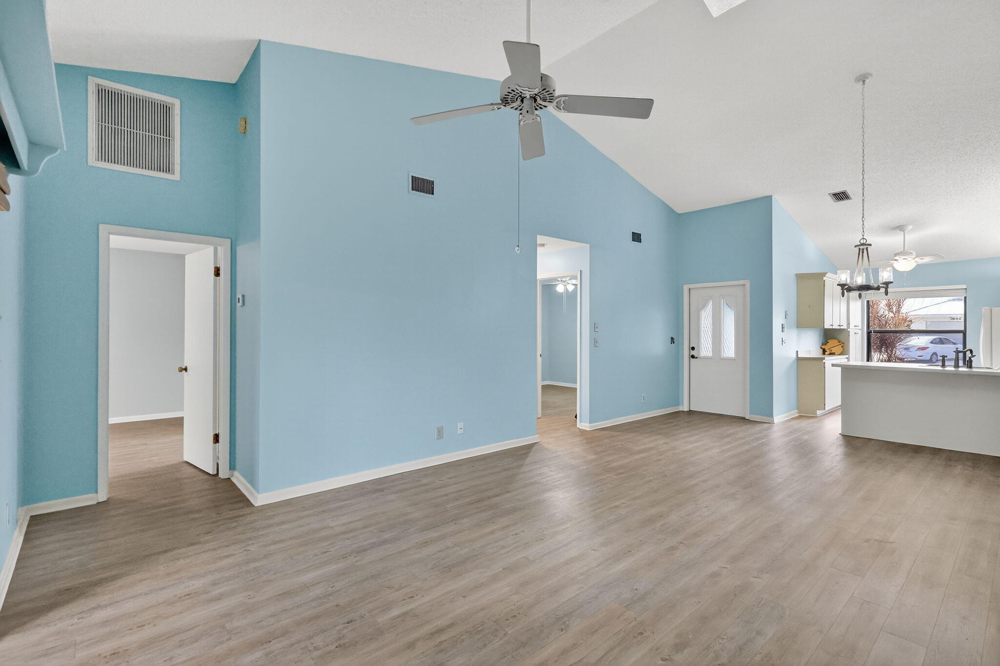7643 Southeast Sugar Sand Circle Hobe Sound, FL 33455 - Photo 43 of 44 a view of a kitchen with wooden floor and a ceiling fan