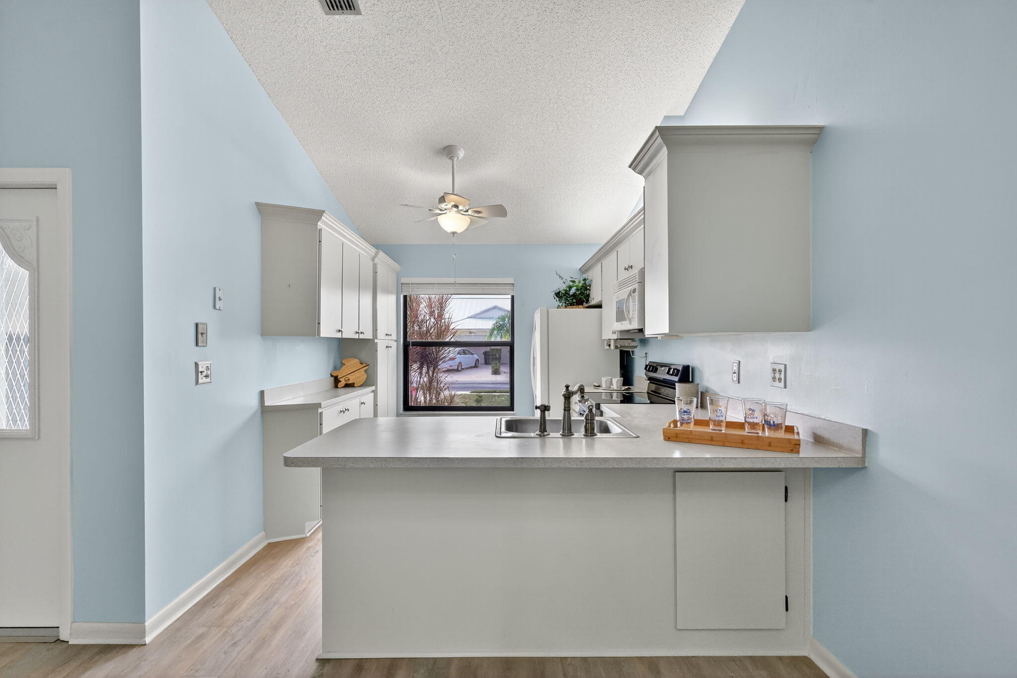 7643 Southeast Sugar Sand Circle Hobe Sound, FL 33455 - Photo 6 of 44 a bathroom with a sink and a mirror