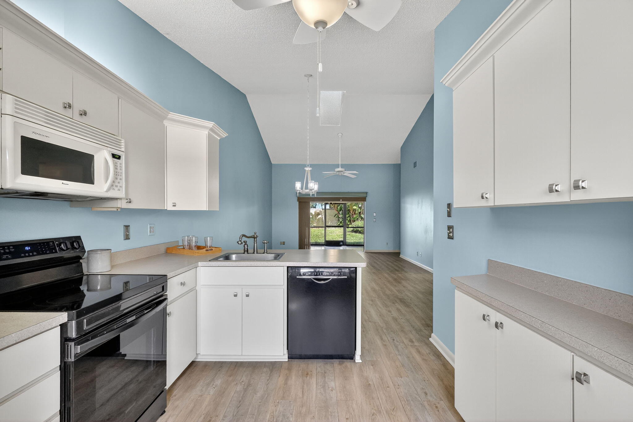 7643 Southeast Sugar Sand Circle Hobe Sound, FL 33455 - Photo 8 of 44 a kitchen with a sink stove and cabinets