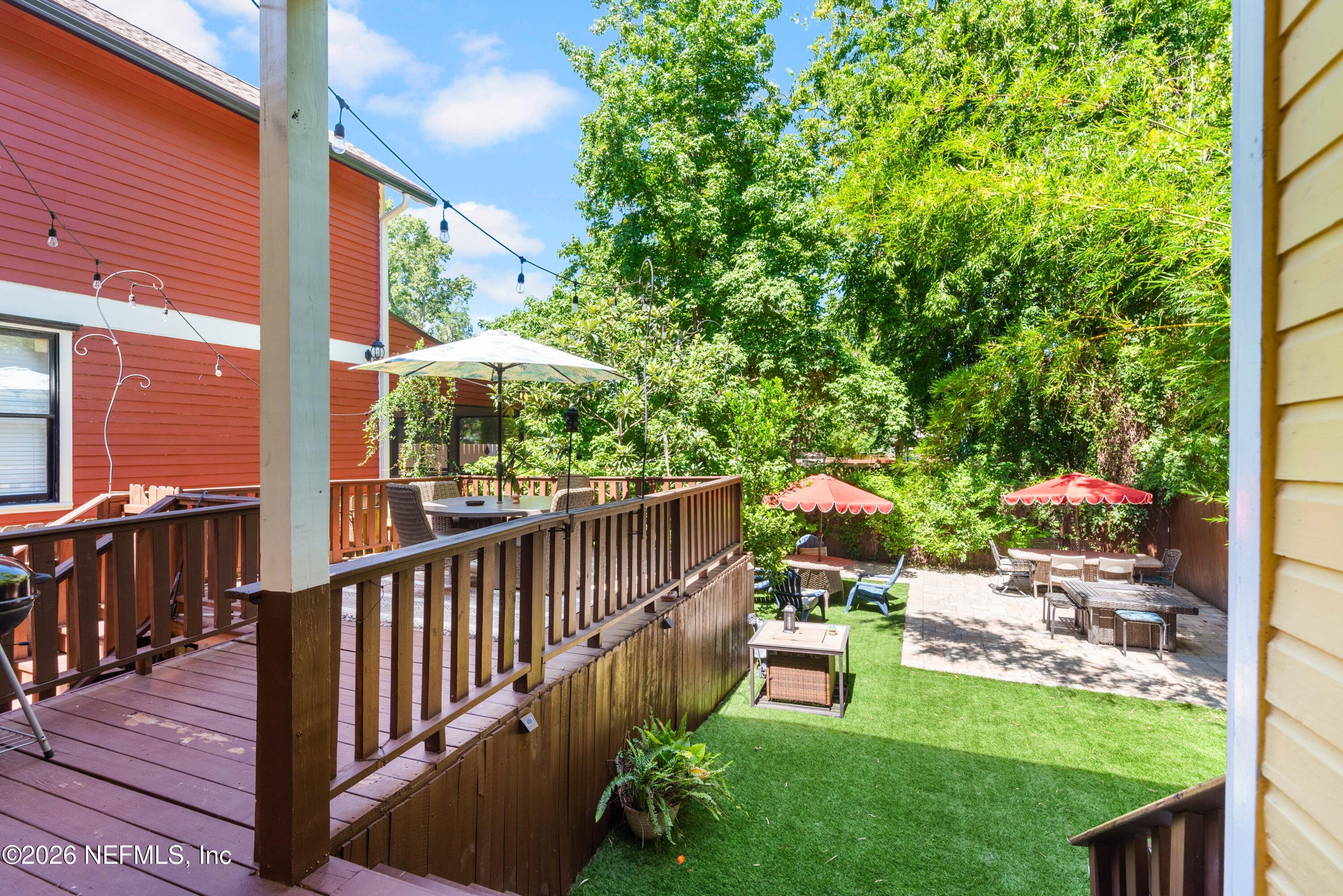 1138 Walnut Street Jacksonville, FL 32206 - Photo 17 of 37 a balcony with couple of flower plants and wooden fence