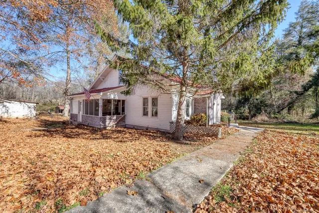 a view of a house with a snow on the side of the road
