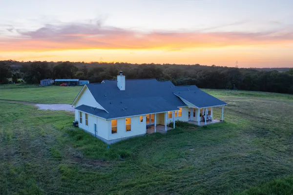 a aerial view of a house with big yard