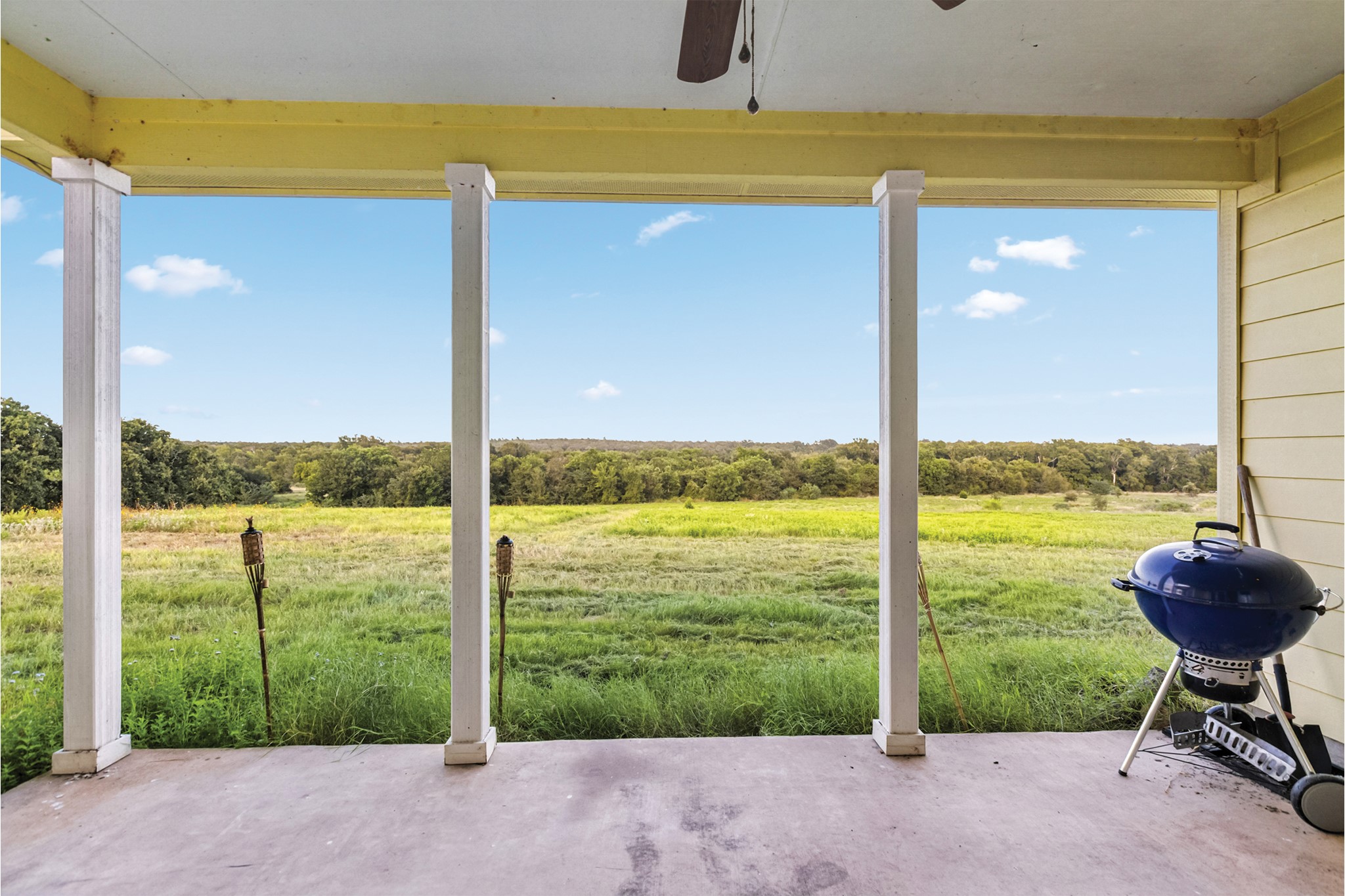 498 North County Line Road Elgin, TX 78621 - Photo 11 of 40 View of patio with area for grilling, a view of countryside, and view of wooded area